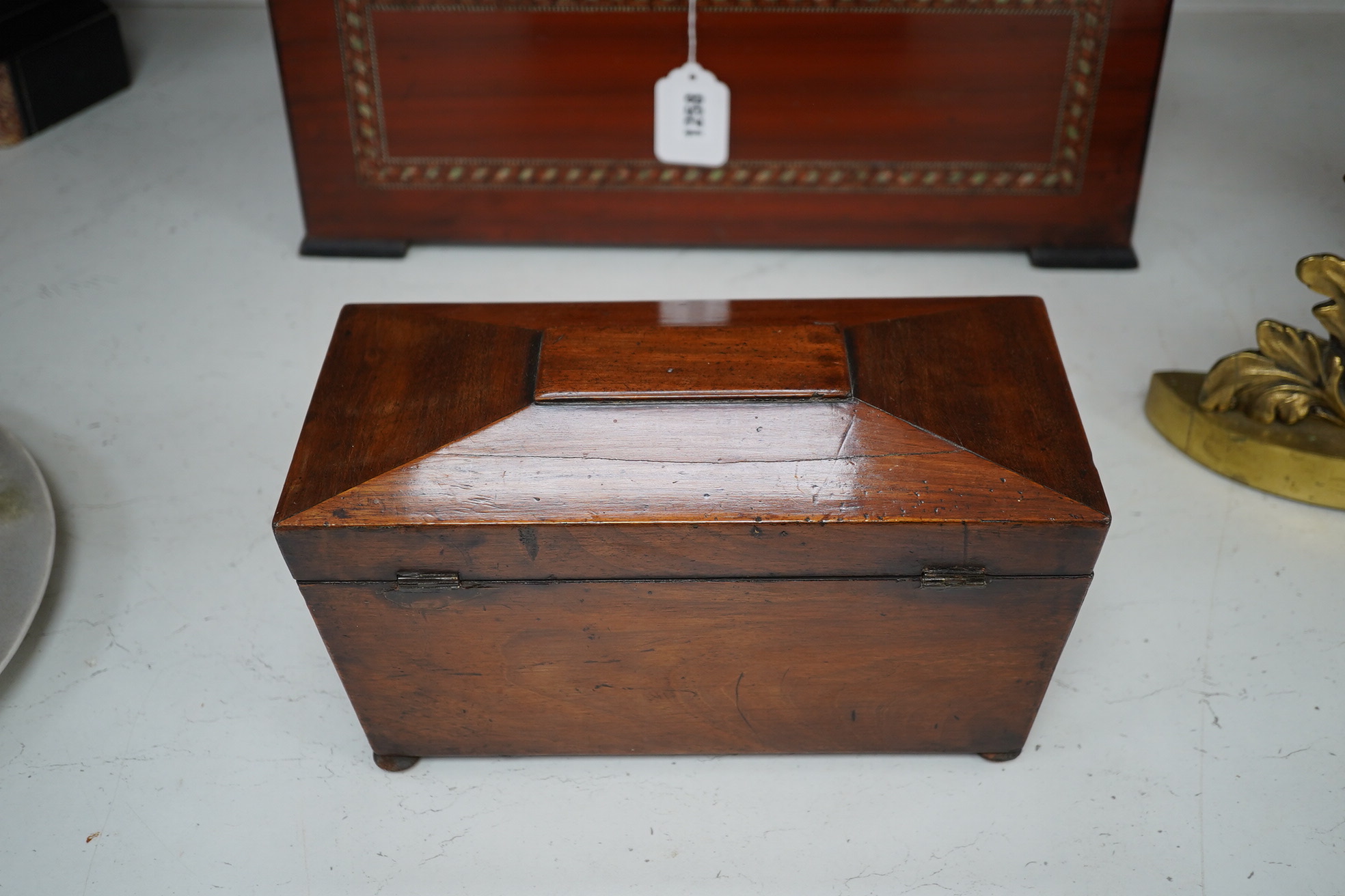 A Victorian mahogany sarcophagus shaped tea caddy with mother of pearl inlaid escutcheon, 28cm. Condition - fair